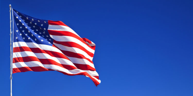 American flag fluttering in the blue sky