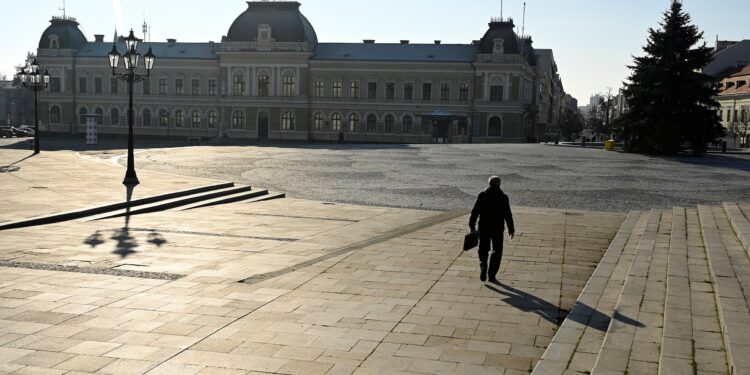 FILE PHOTO: A man walks through the empty downtown, amid the spread of the coronavirus disease (COVID-19),  in Nitra, Slovakia January 11, 2021. REUTERS/Radovan Stoklasa