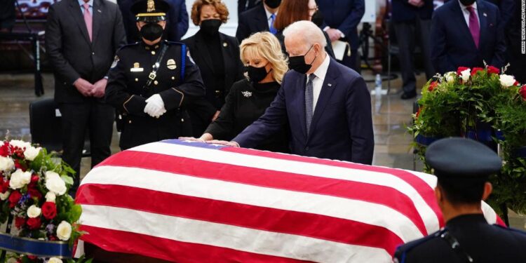 US President Joe Biden (R) and US First Lady Dr. Jill Biden at the casket of former Republican Senator from Kansas Robert J. Dole during a ceremony preceding the lying in state in the Rotunda of the US Capitol in Washington, DC, on December 9, 2021. (Photo by SHAWN THEW / POOL / AFP) (Photo by SHAWN THEW/POOL/AFP via Getty Images)
