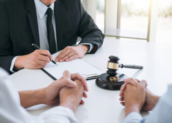 Agreement prepared by lawyer signing decree of divorce (dissolution or cancellation) of marriage, husband and wife during divorce process with male lawyer or counselor and signing of divorce contract.