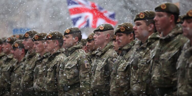 BLACKBURN, ENGLAND - DECEMBER 01:  Soldiers of The 1st Battalion Duke of Lancaster's Regiment brave the snow as they march through the streets of Blackburn following a six-month tour of duty in Afghanistan on December 1, 2010 in Blackburn, England. The 120 soldiers exercised their right to the freedom of the city by taking part in a thanksgiving service at Blackburn Cathedral and parading through the streets.  (Photo by Christopher Furlong/Getty Images)