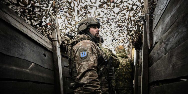 TOPSHOT - Ukrainian troops patrol at the frontline outside the town of Novoluhanske, eastern Ukraine, on February 19, 2022. - Ukraine's army said Saturday that two of its soldiers died in attacks in on the frontline with Russian-backed separatists, the first fatalities in the conflict in more than a month. "As a result of a shelling attack, two Ukrainian servicemen received fatal shrapnel wounds," the military command for the separatist conflict said. (Photo by ARIS MESSINIS / AFP) (Photo by ARIS MESSINIS/AFP via Getty Images)