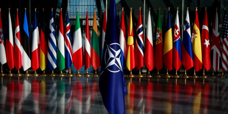 epa09535553 A view of a NATO flag placed in front of the flags of the alliance's member states (rear) ahead of a meeting of the NATO Ministers of Defence at the NATO headquarters in Brussels, Belgium, 21 October 2021. The meeting takes place in Brussels on 21 and 22 October 2021.  EPA/STEPHANIE LECOCQ
