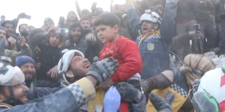 Rescuers cheer as a boy is pulled from the rubble during a rescue following an earthquake in Bisnia, Syria February 7, 2023 in this still image from social media video. White Helmets via REUTERS    THIS IMAGE HAS BEEN SUPPLIED BY A THIRD PARTY. MANDATORY CREDIT. NO RESALES. NO ARCHIVES