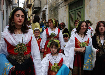 PIANA DEGLI ALBANESI, ITALY - APRIL 11:  Arbereshe girls dressed in their traditional costumes attends the Procession Of The Misteri after Easter Sunday Holy Mass April 11, 2004 in Piana degli Albanesi, Sicily, Italy. Piana degli Albanesi, with approximately 6,000 Arberereshe residents, is the most important of the five Albanian settlements in Sicily. The Arberereshe are the decendents of Albanians who immigrated to Sicily during the 15th century after the Turkish invasion in Albania. All the residents still keep their traditions and speak Arberes which will soon be taught in schools. On Holy Easter Sunday after Mass, the girls continue the Greek-byzantine rite where girls, dressed in their traditional Arbereshe costumes, walk in procession along the streets of the village called the Procession Of The Misteri where they deliver consecrated red eggs.  (Photo by Marco Di Lauro/Getty Images)