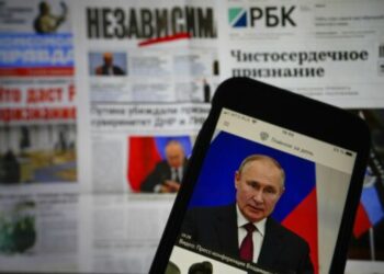 The app of the Russian government newspaper is displayed on an iPhone screen showing Russian President Vladimir Putin during his speech in the Kremlin in Moscow, Russia, Tuesday, Feb. 22, 2022. As the West sounds the alarm about the Kremlin ordering troops into eastern Ukraine and decries an invasion, Russian state media paints a completely different picture. It portrays the move as Moscow coming to the rescue of war-torn areas tormented by Ukraine’s aggression and bringing them much-needed peace. (AP Photo/Alexander Zemlianichenko Jr)
